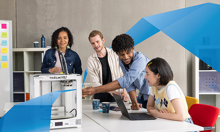 Diverse group of students working together by 3D printer. 