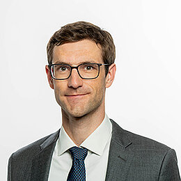 Headshot of Prof. Dr. Timm Betz, a middle age man smiling on a simple white  background.