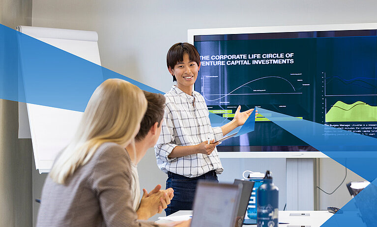 Female asian FIM student presents something to her fellow students via powerpoint