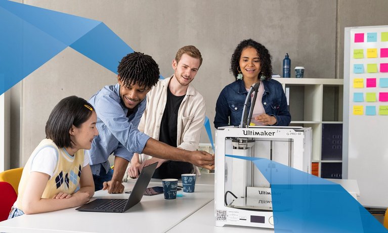 Diverse group of students working together by 3D printer. 