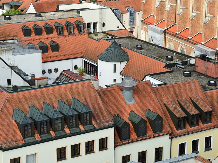 A collection of houses with red roof and black windows