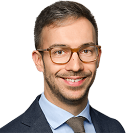 Headshot of Prof. Dr. Michael Kurschilgen, a young man smiling on a simple white background.
