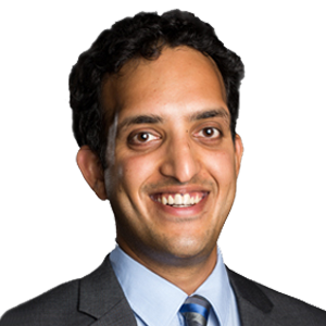 Headshot of Prof. Dr Siddharth Vedula, a middle aged man smiling on a simple white background.